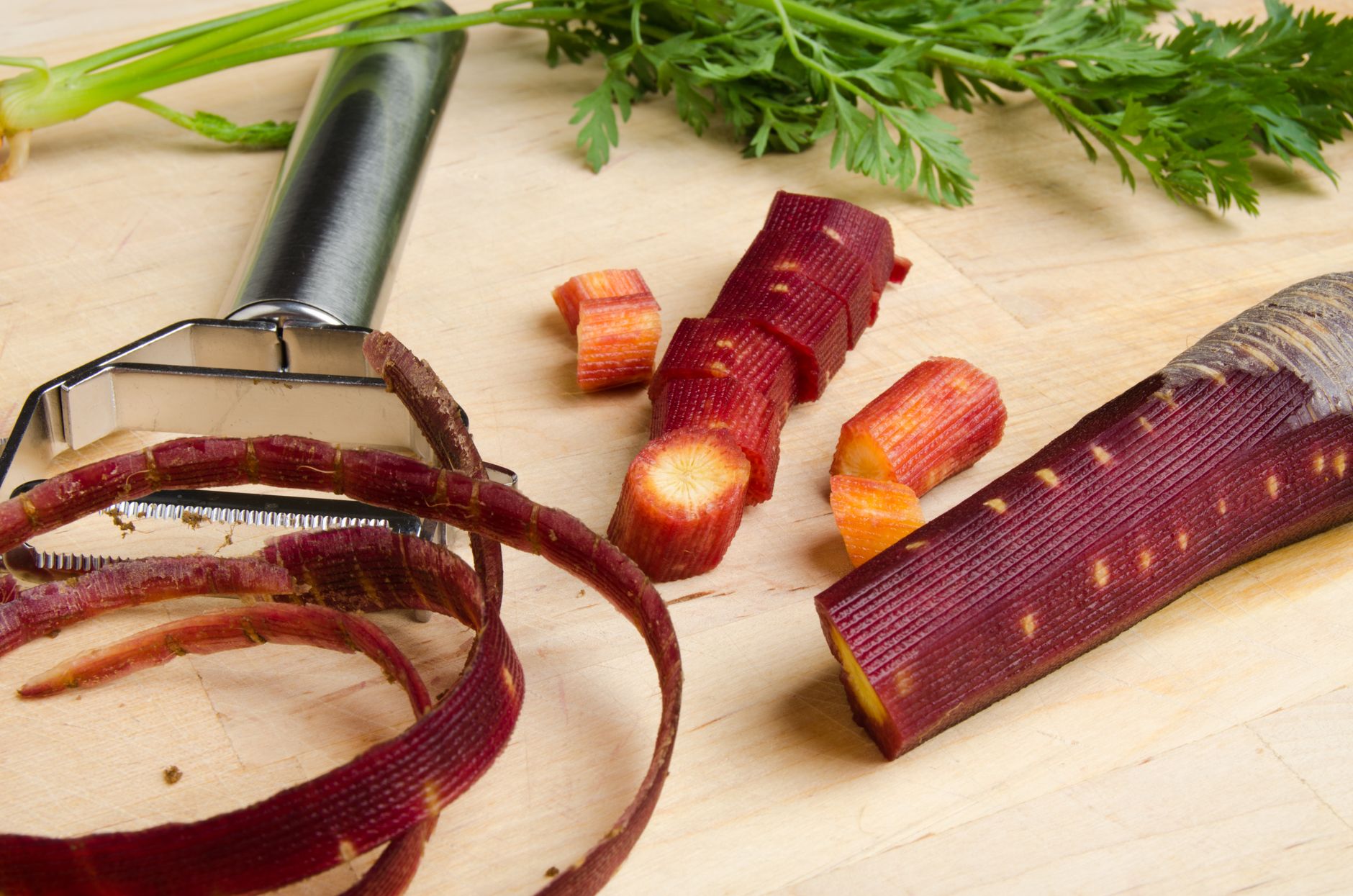 Carrot peels and scraps on a cutting board