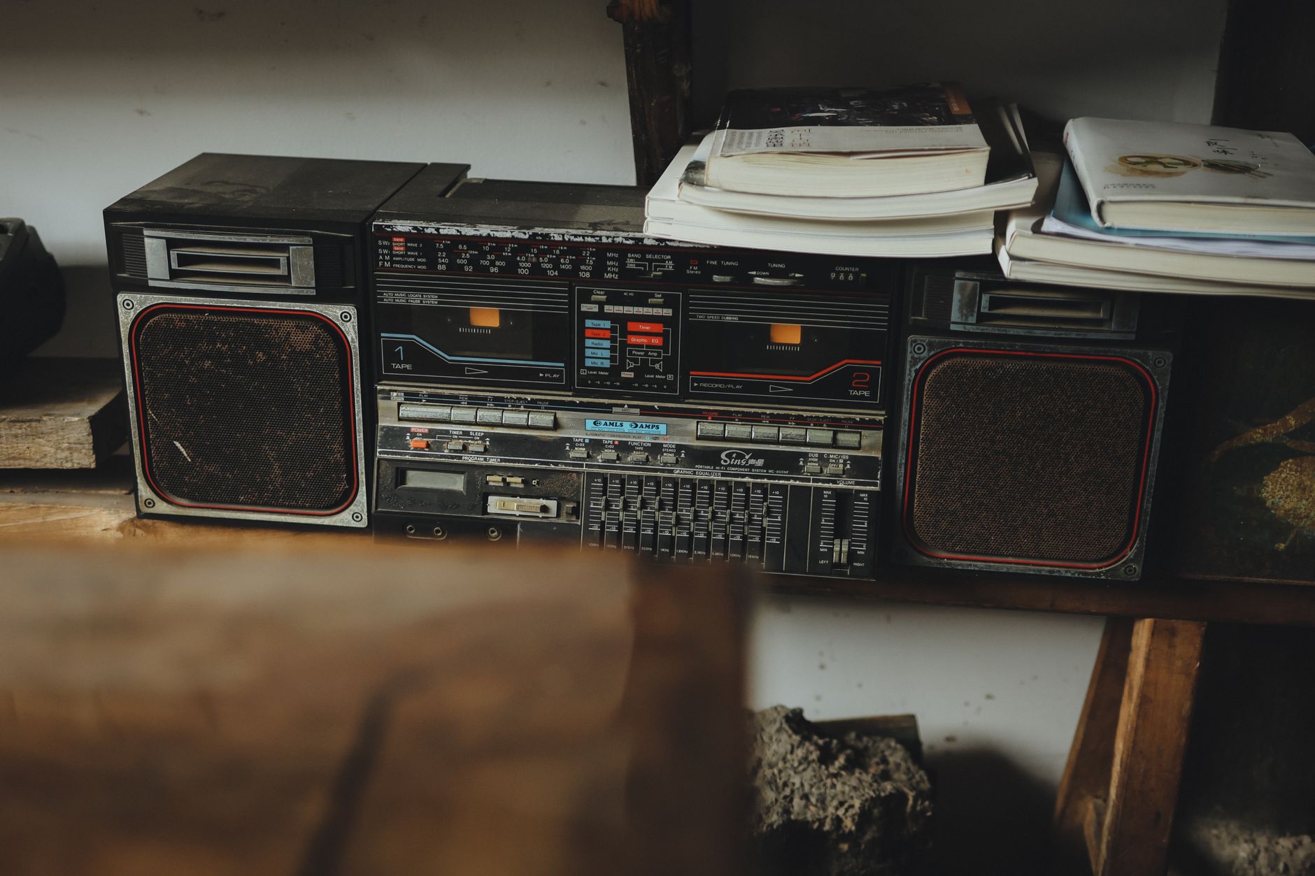 A speaker on a bookshelf
