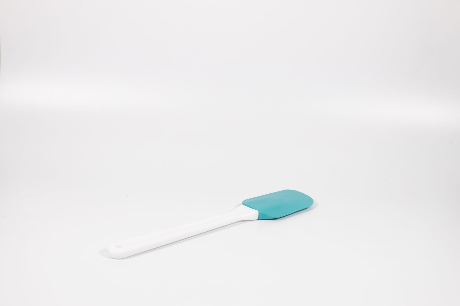 A silicone spatula on a white surface