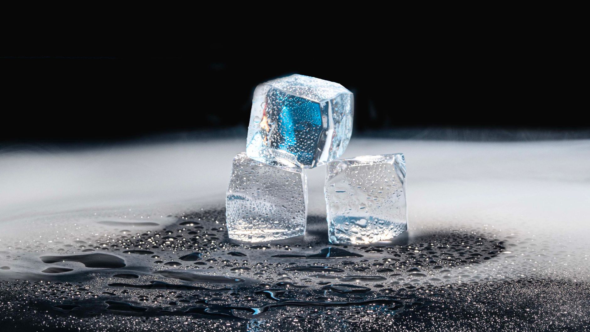 Ice cubes on a dark surface