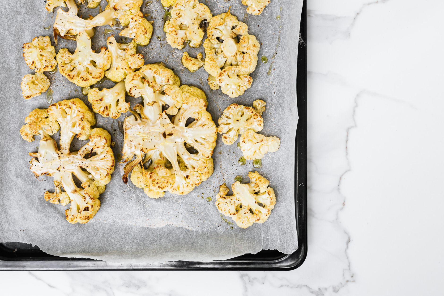 Roasted cauliflower on a lined sheet pan