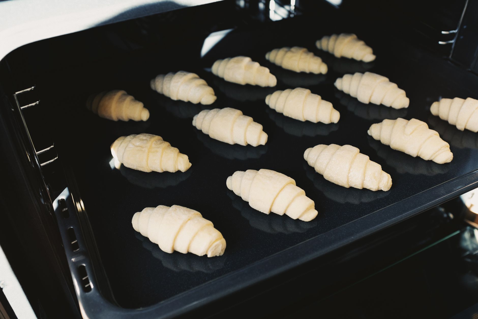 Croissants on a baking tray in an oven