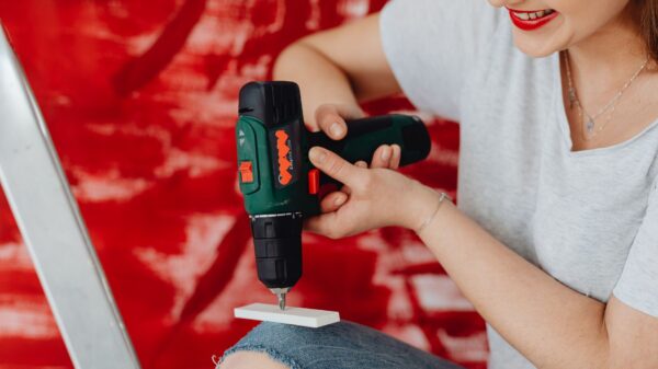 A woman using a cordless drill