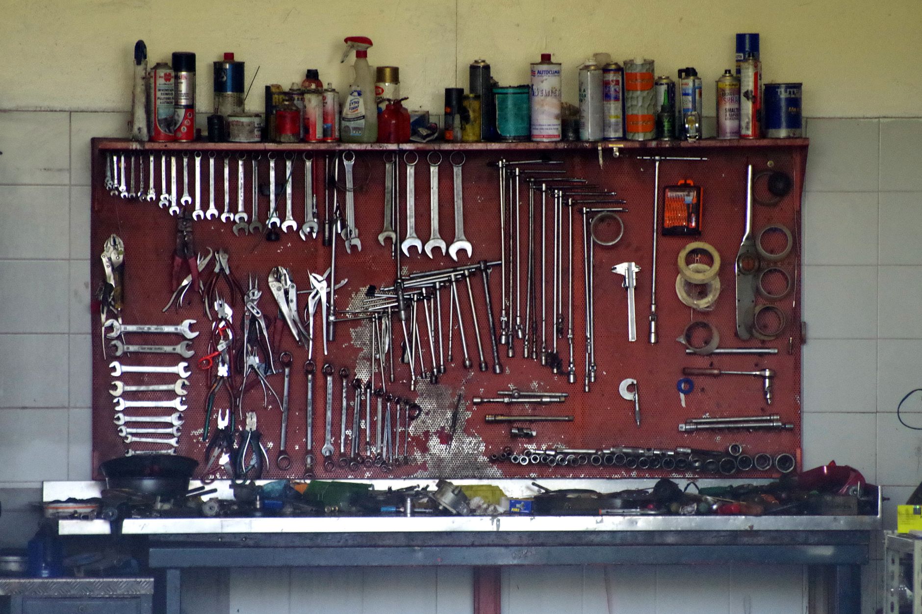Wrenches on a red pegboard