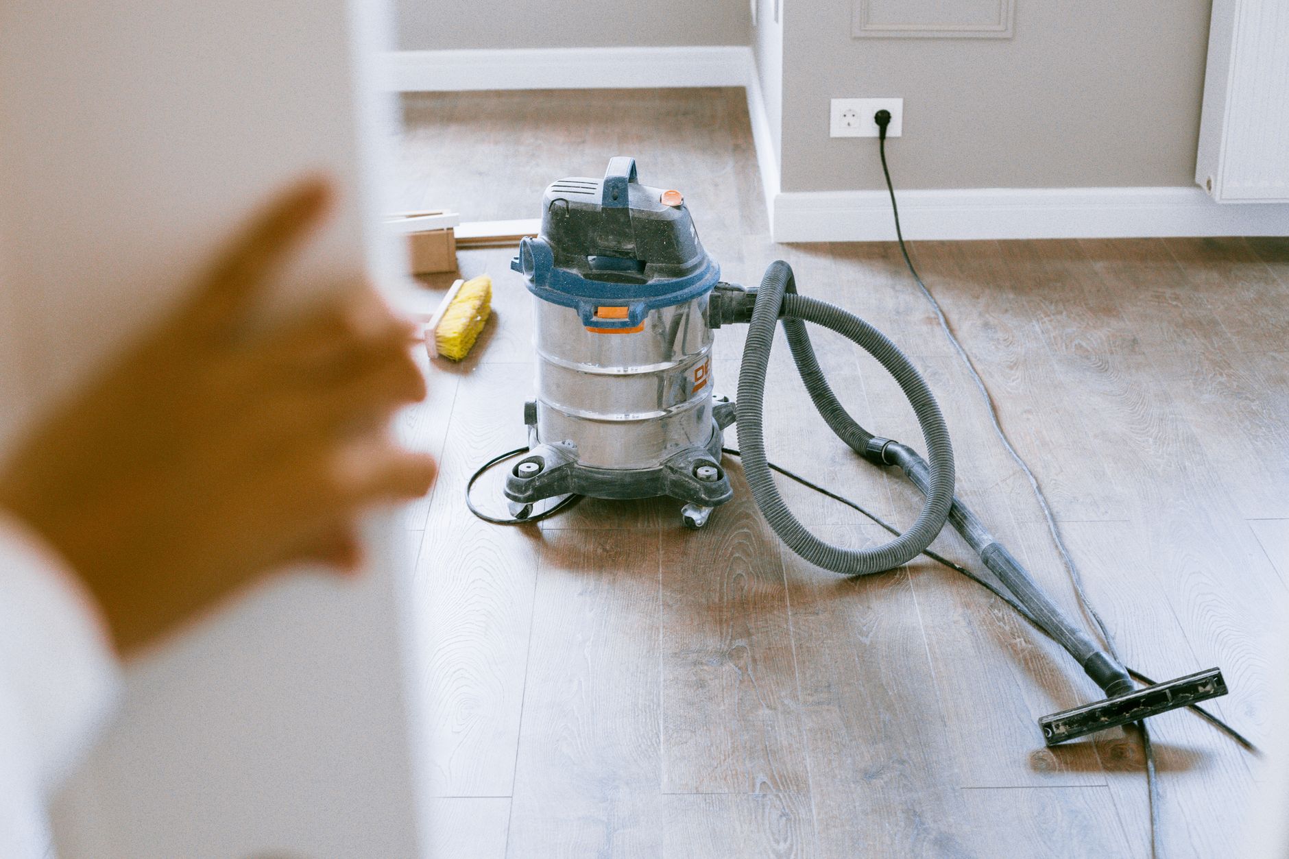 Wet-dry canister vacuum on a hardwood floor