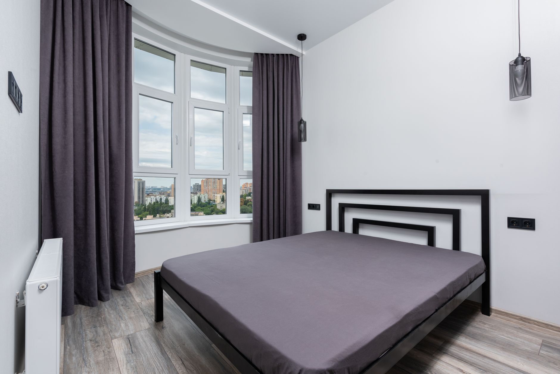 Dark curtains drawn across a bedroom window