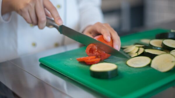 Slicing zucchini on a green cutting board