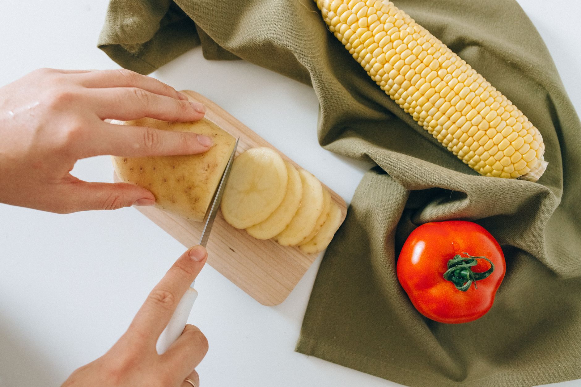 Slicing a potato on a small board