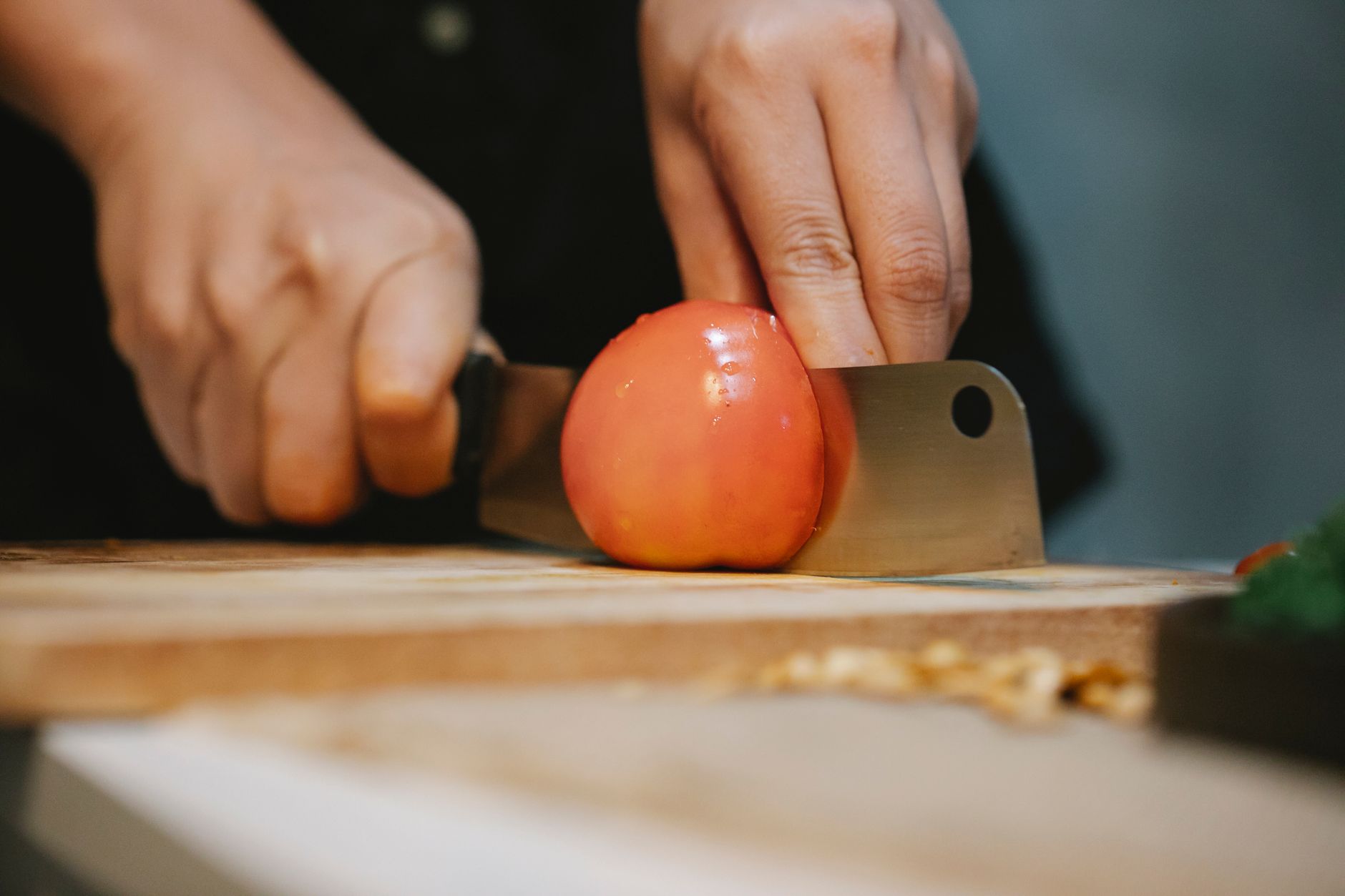 Cutting a tomato with a cleaver