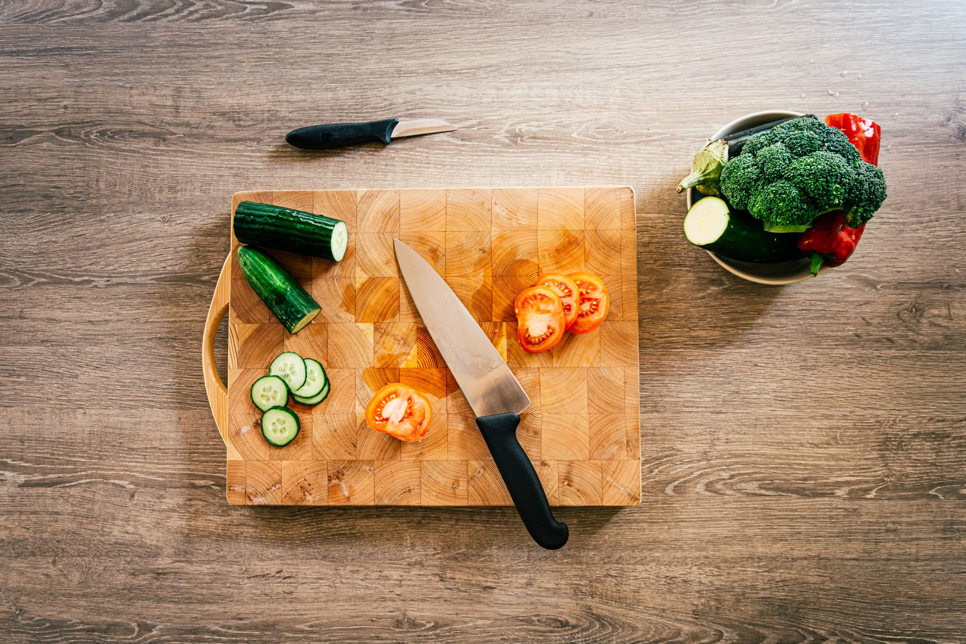 Sliced vegetables on an end-grain cutting board
