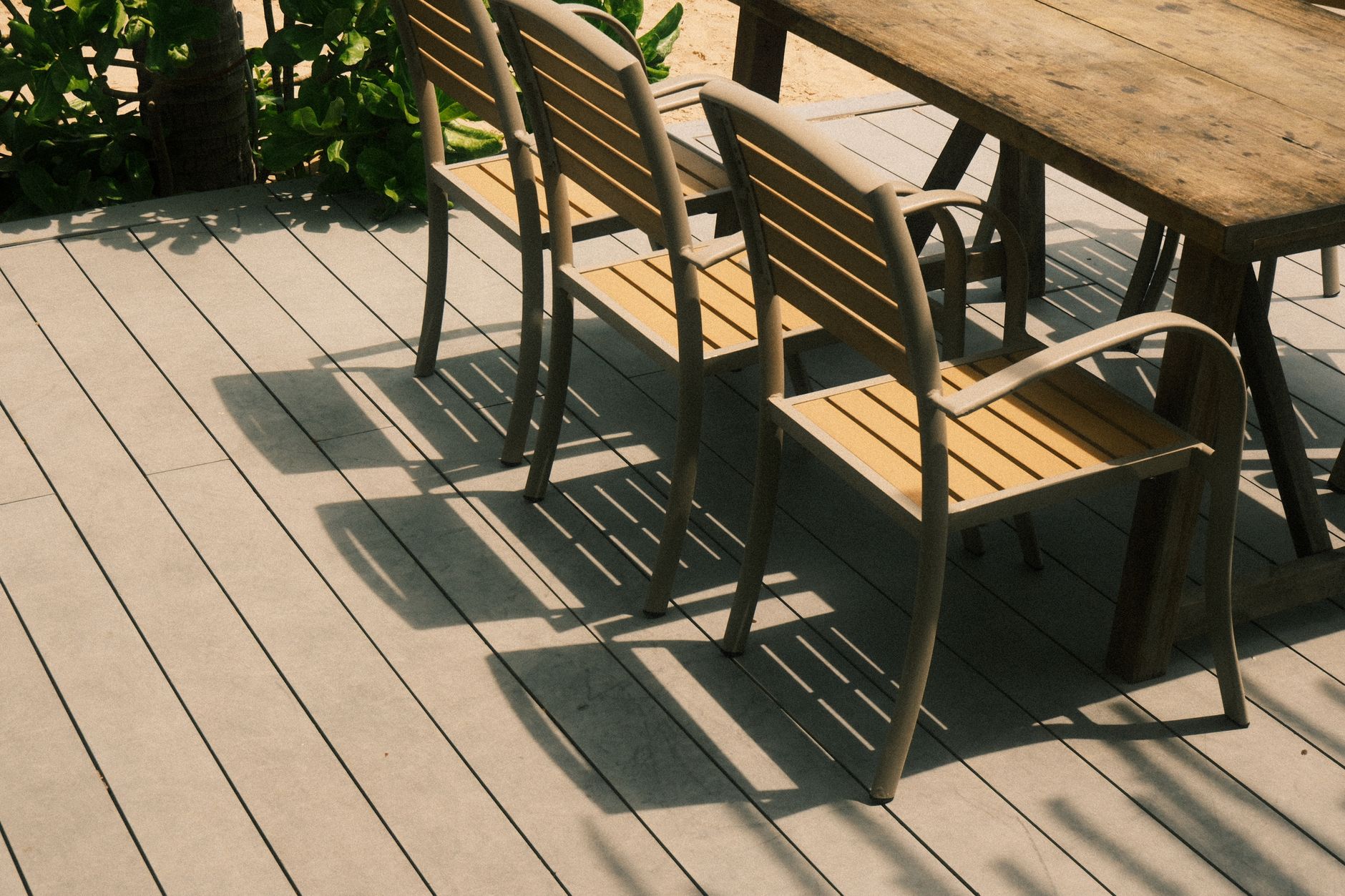 Best deck box: wooden chairs and a table on a backyard deck