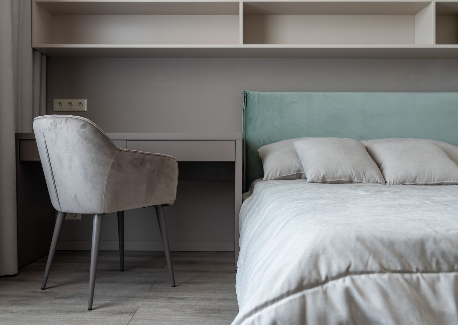 A bedroom with a built-in desk