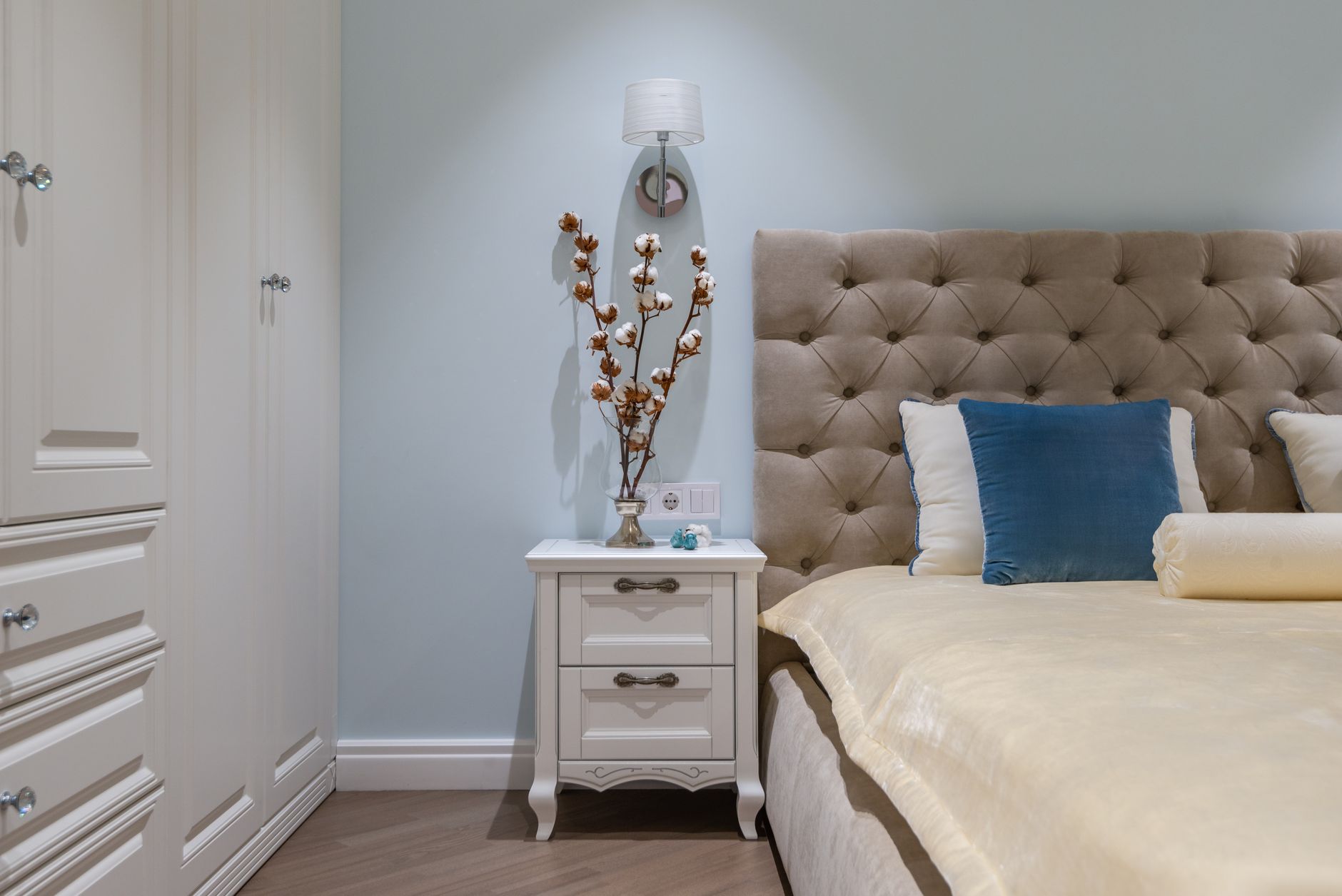 A nightstand beside a bed