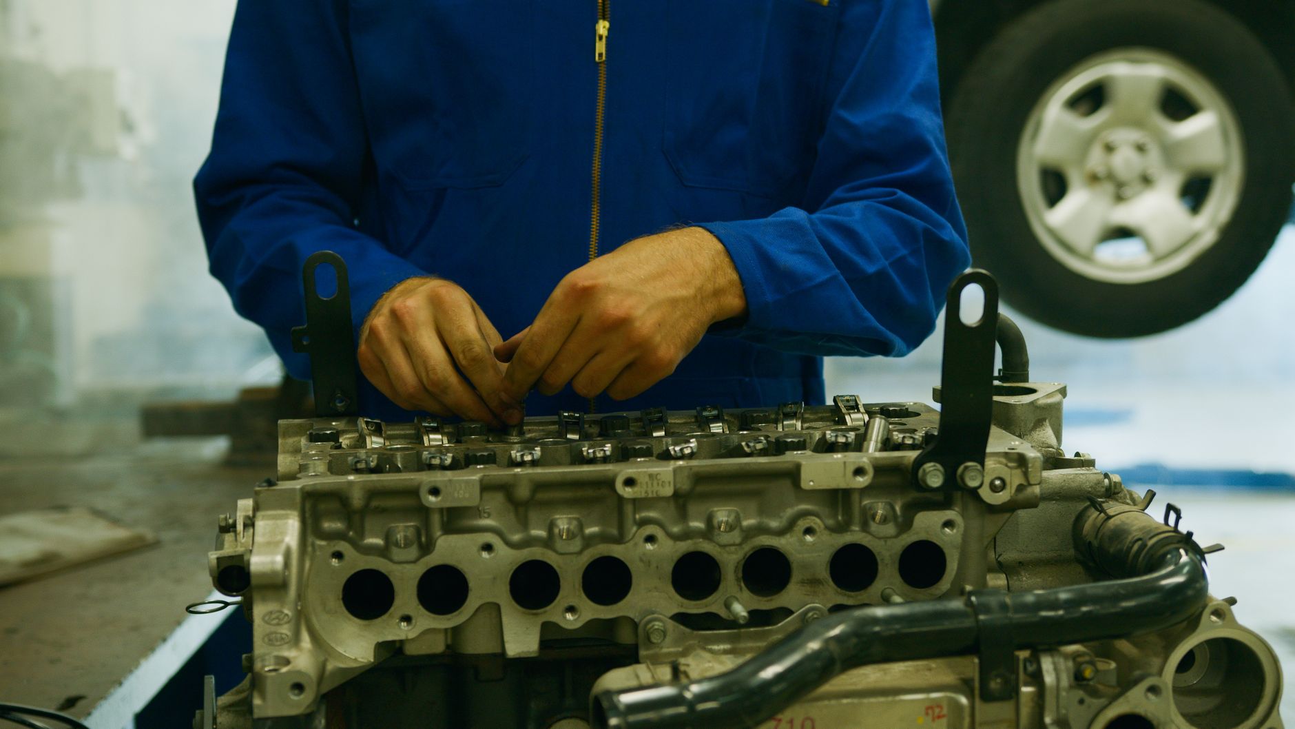 Hands working on a car engine