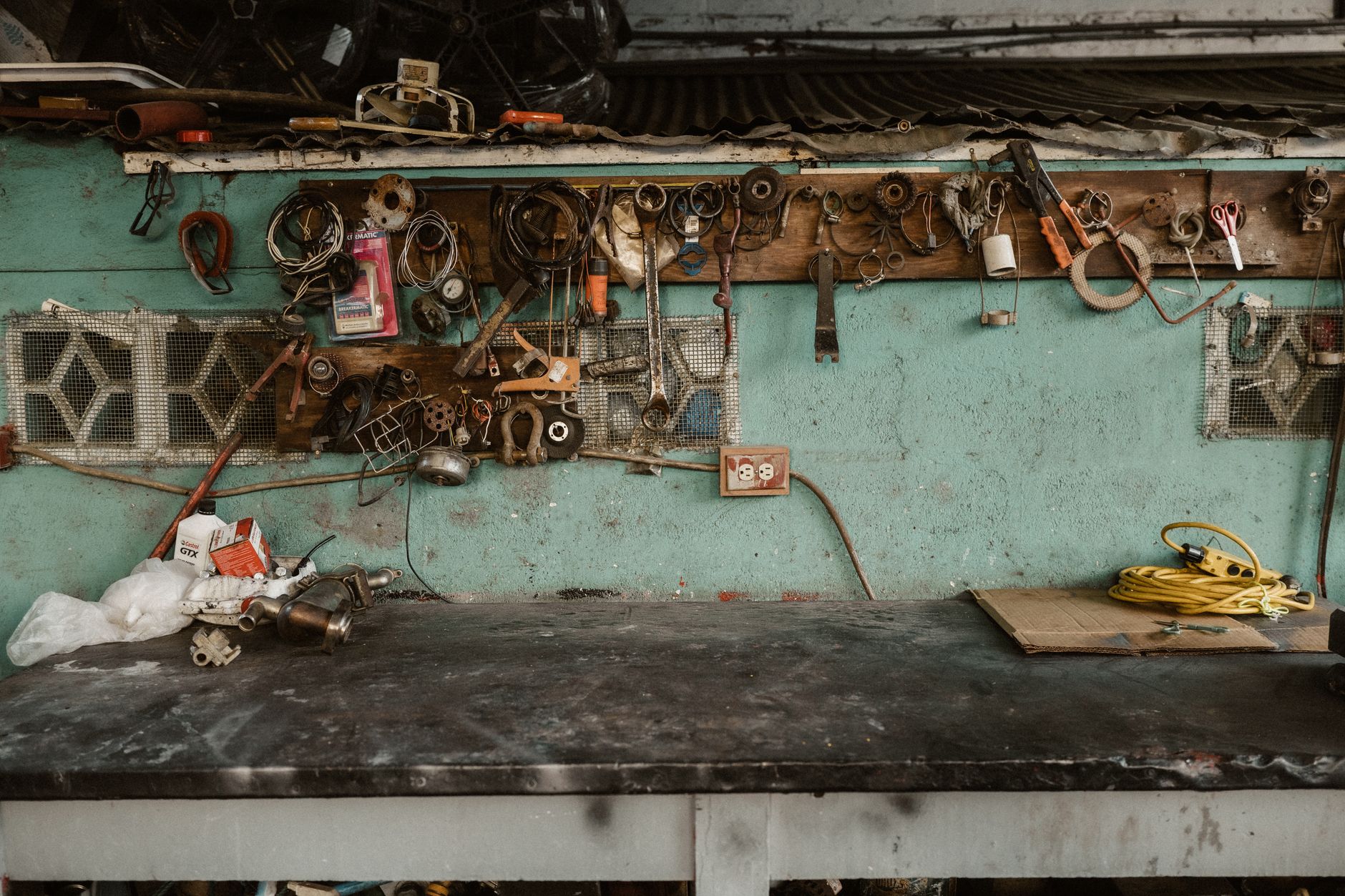 A cluttered garage workbench