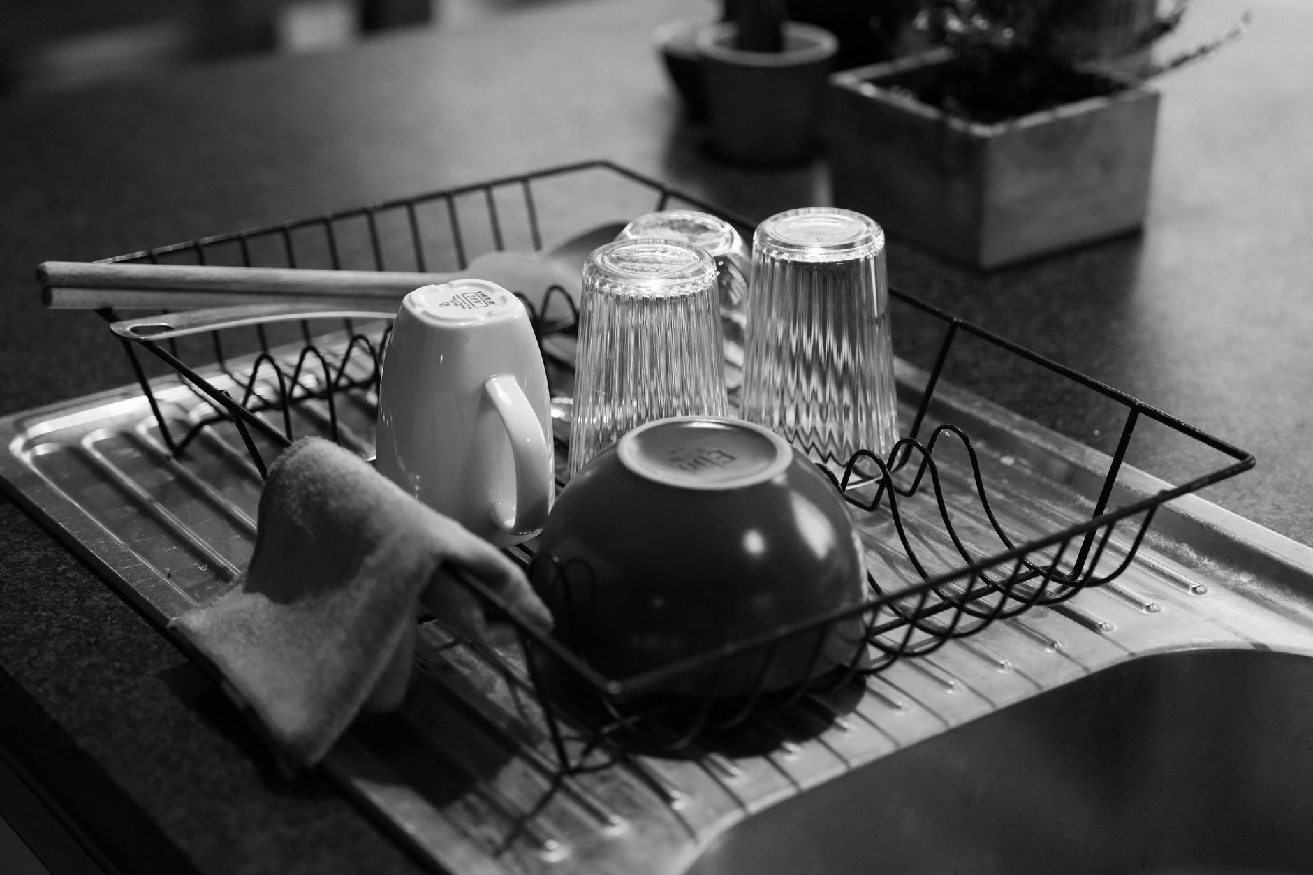 Glasses and mugs drying in a dish rack