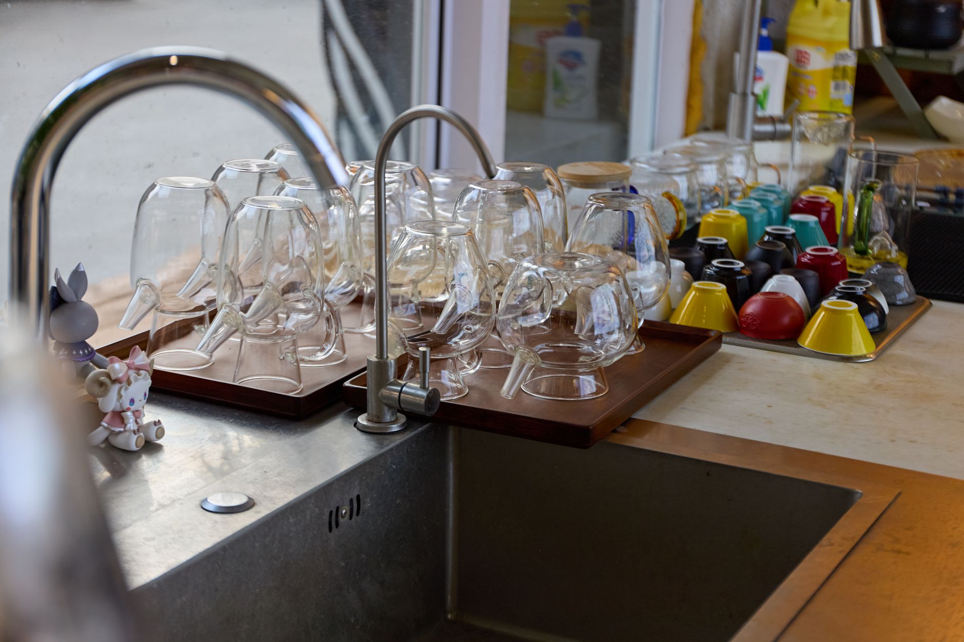 Glasses drying beside a kitchen sink