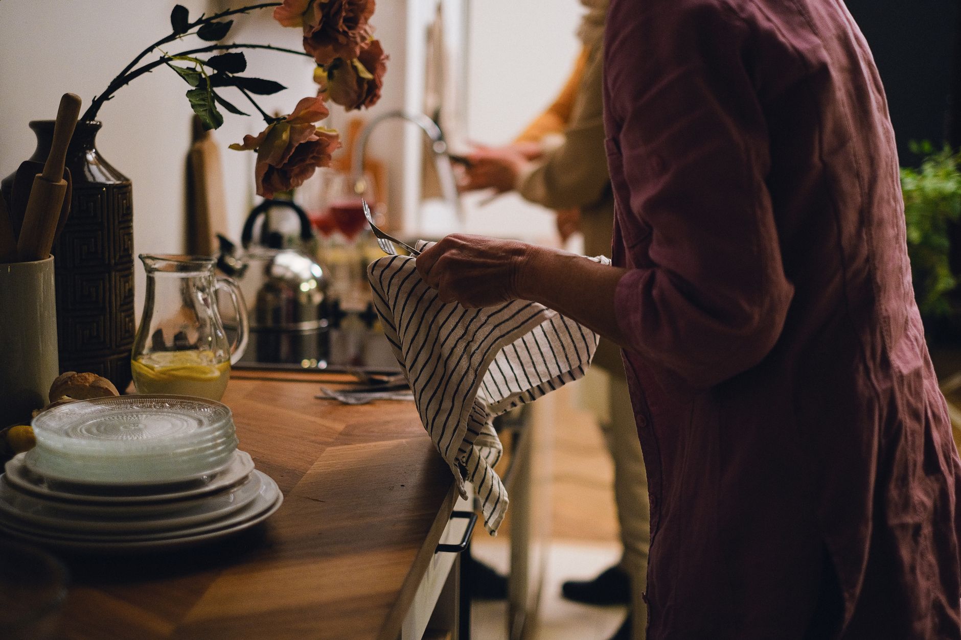 Drying dishes by hand in a home kitchen