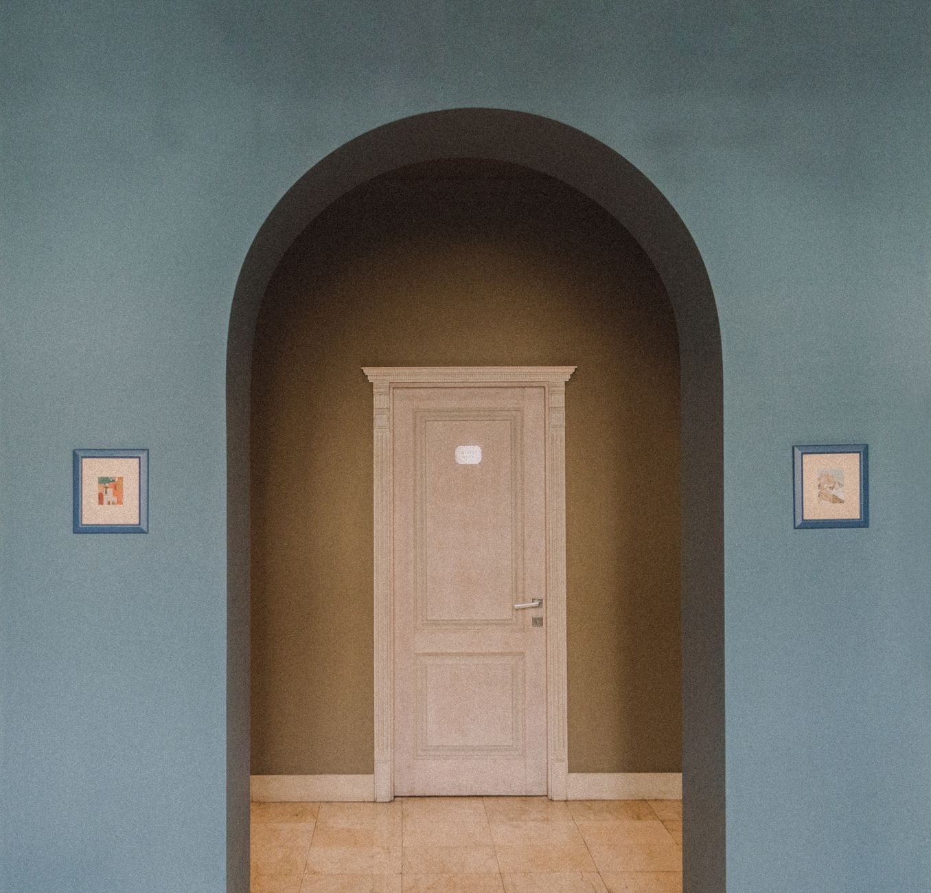 A wooden door set in an arched alcove
