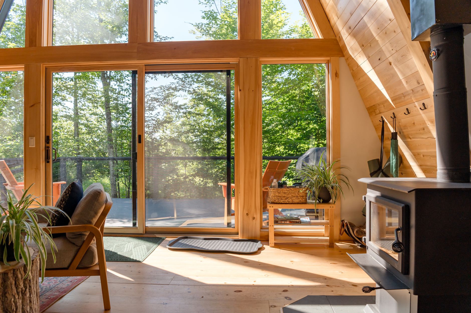 Sliding glass patio doors in a sunny wood-paneled living room