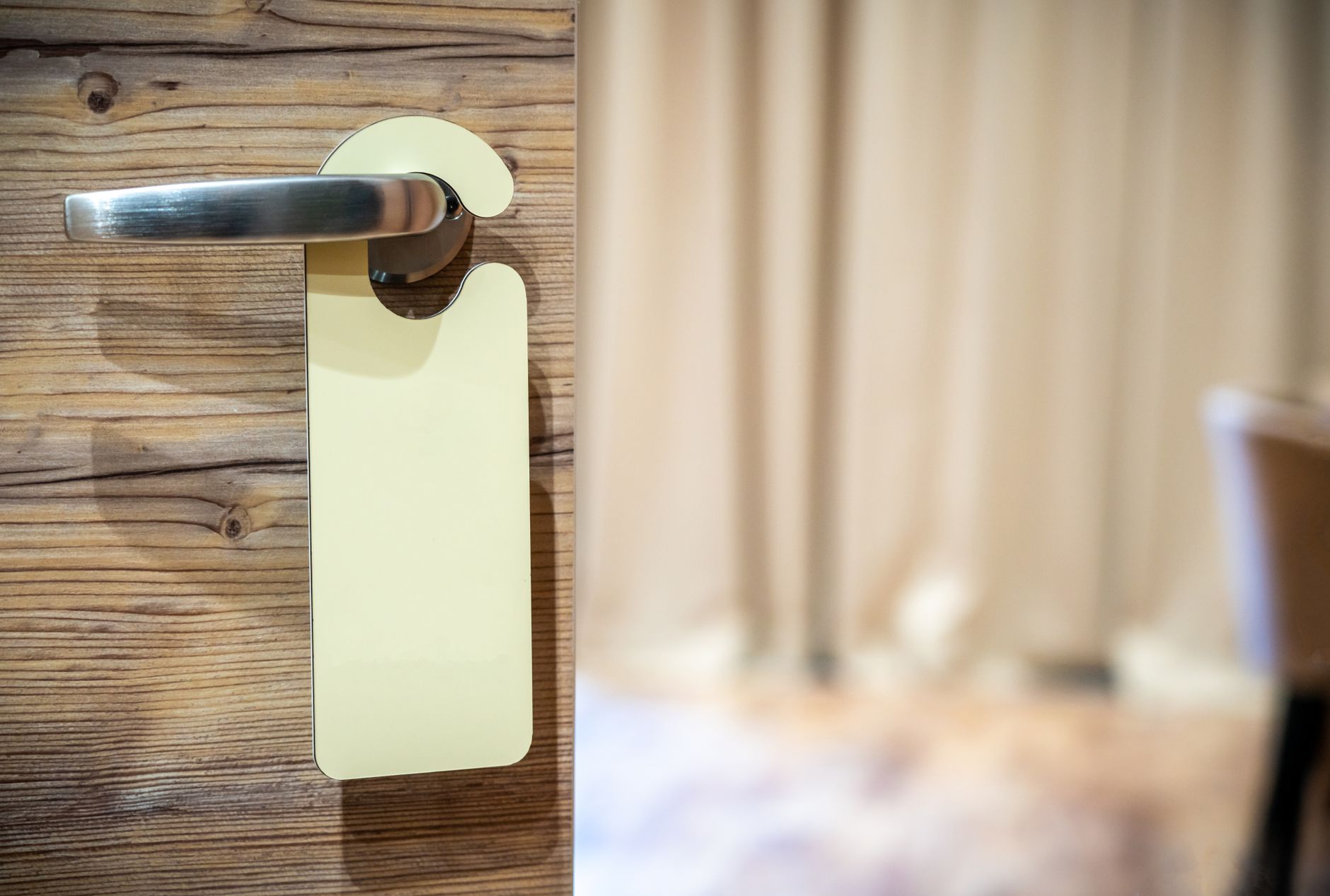 A door hanger on a lever handle of a wooden door
