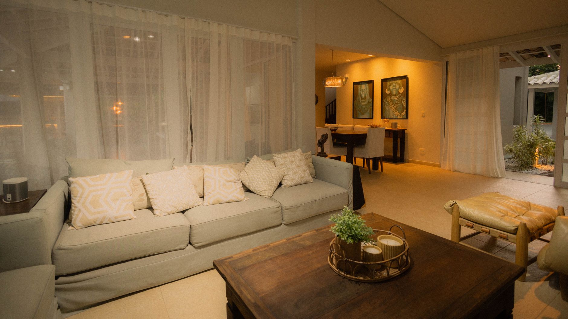 A softly lit living room with a sofa in the evening