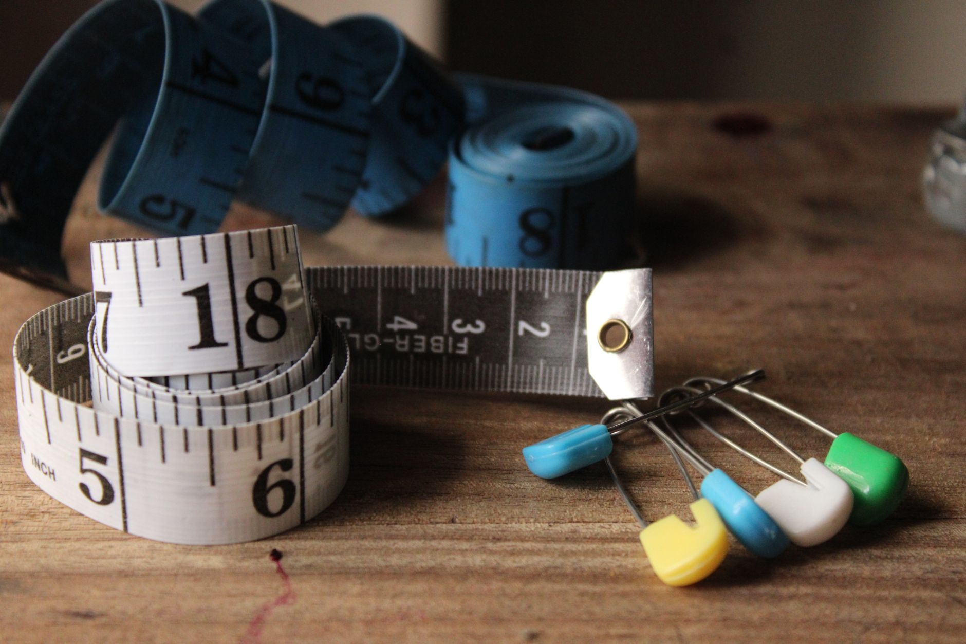 A tape measure and hand tools on a work surface