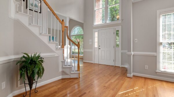 A front entry hall with stairs and a wood floor