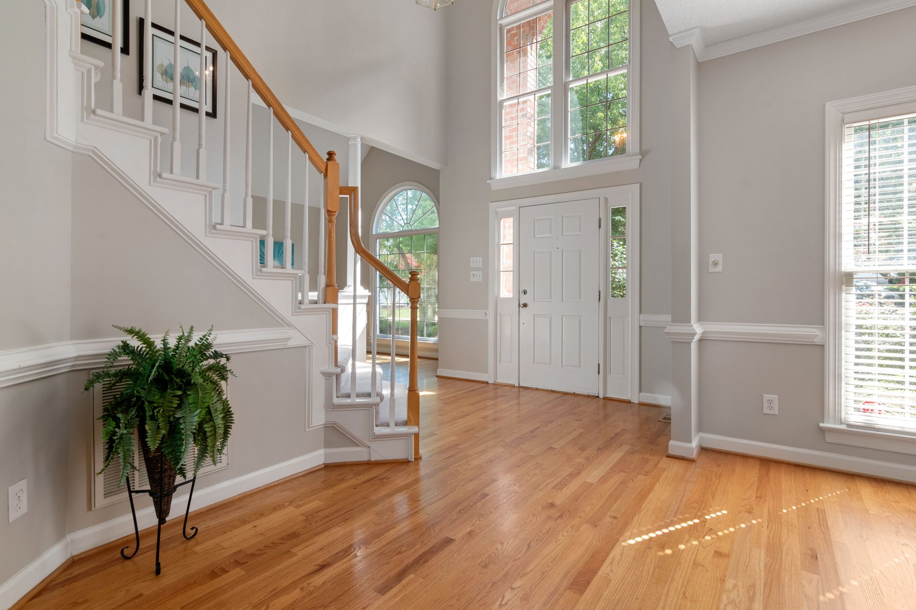A front entry hall with stairs and a wood floor