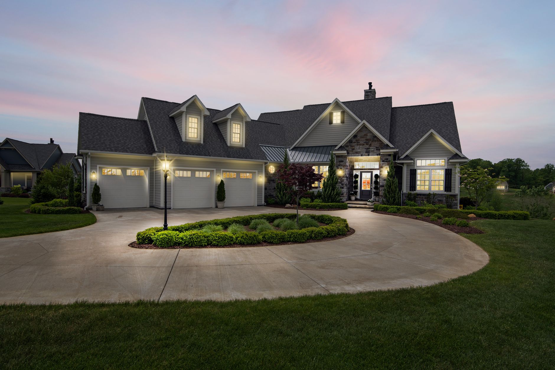 A house and driveway lit at dusk