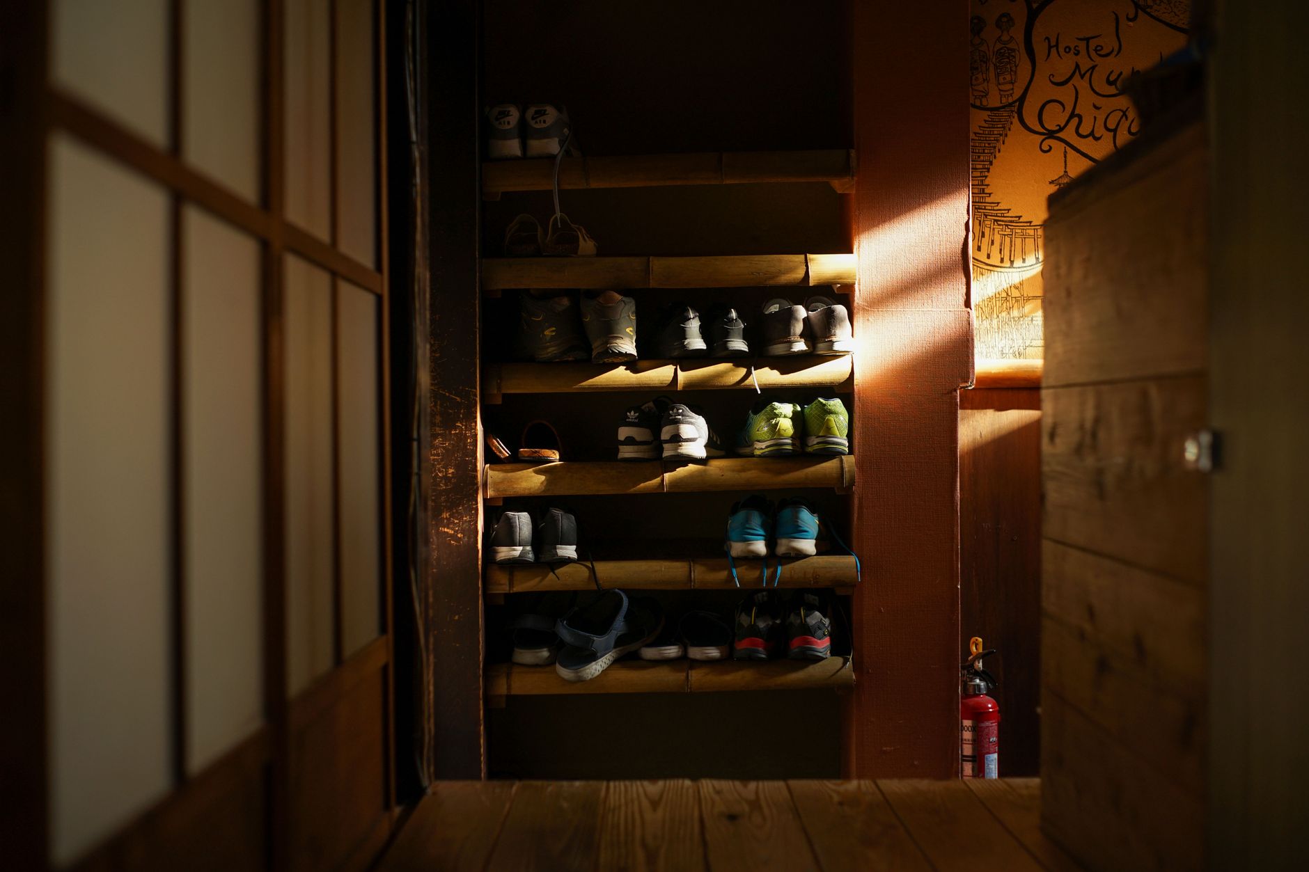 A shoe cubby in a dim entryway