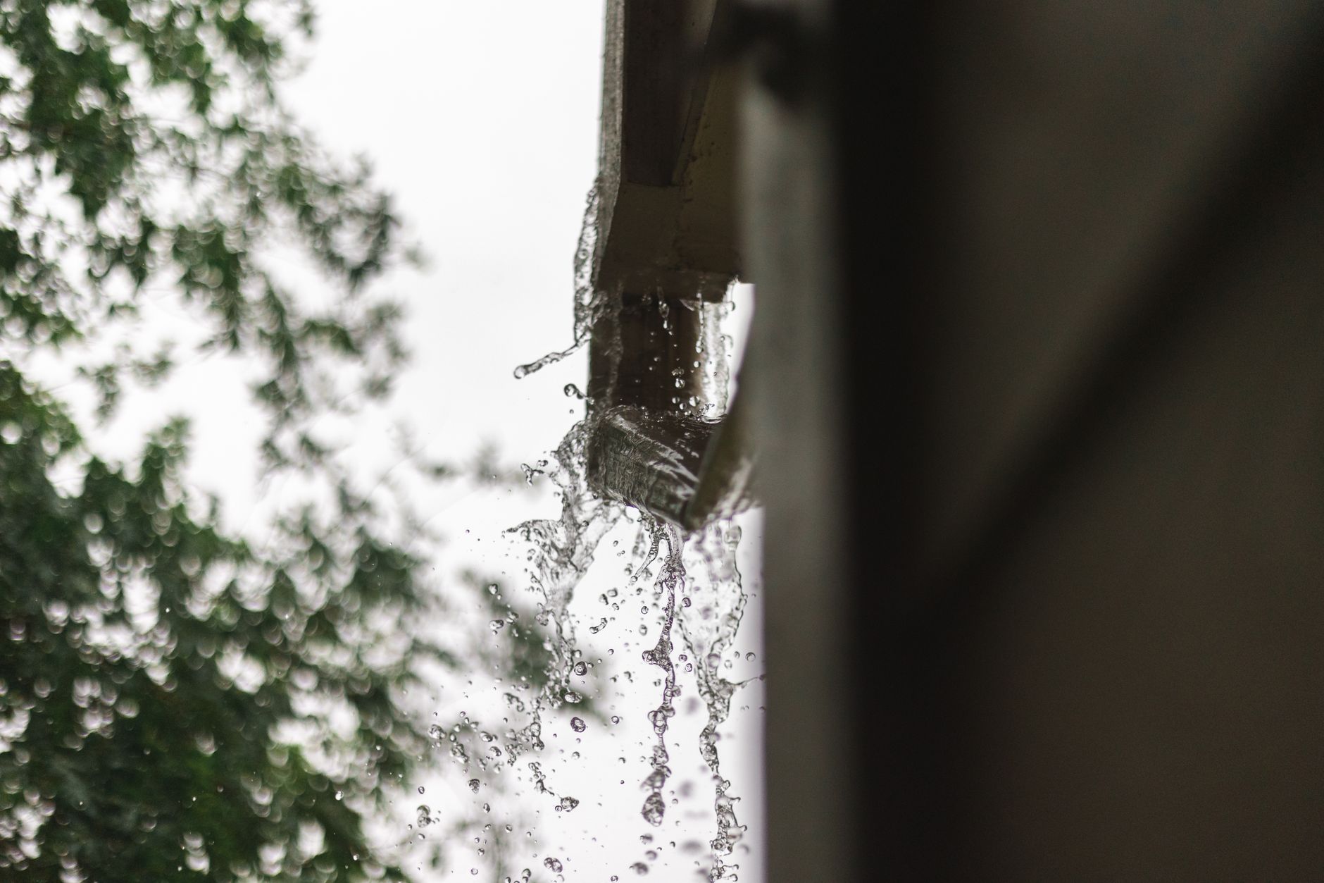 Rain pouring from the end of a downspout