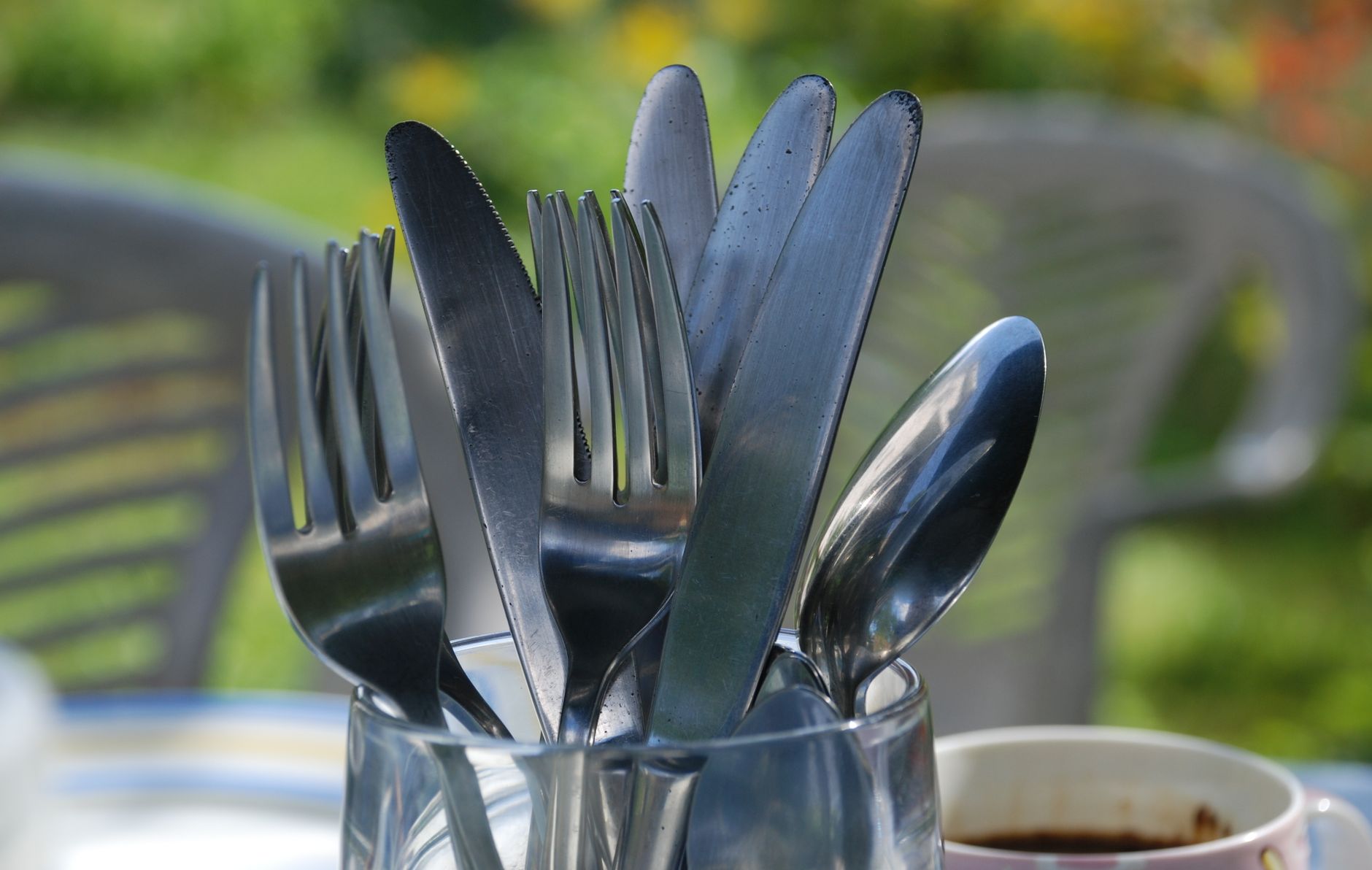 Forks, knives and spoons in a glass holder