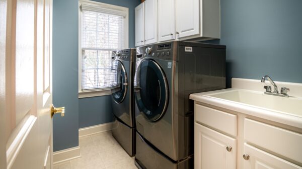 A laundry room with a washer, dryer and utility sink