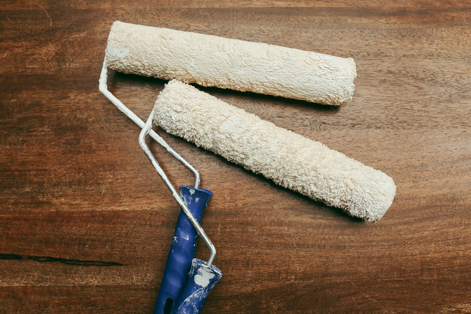Paint rollers on a wooden surface