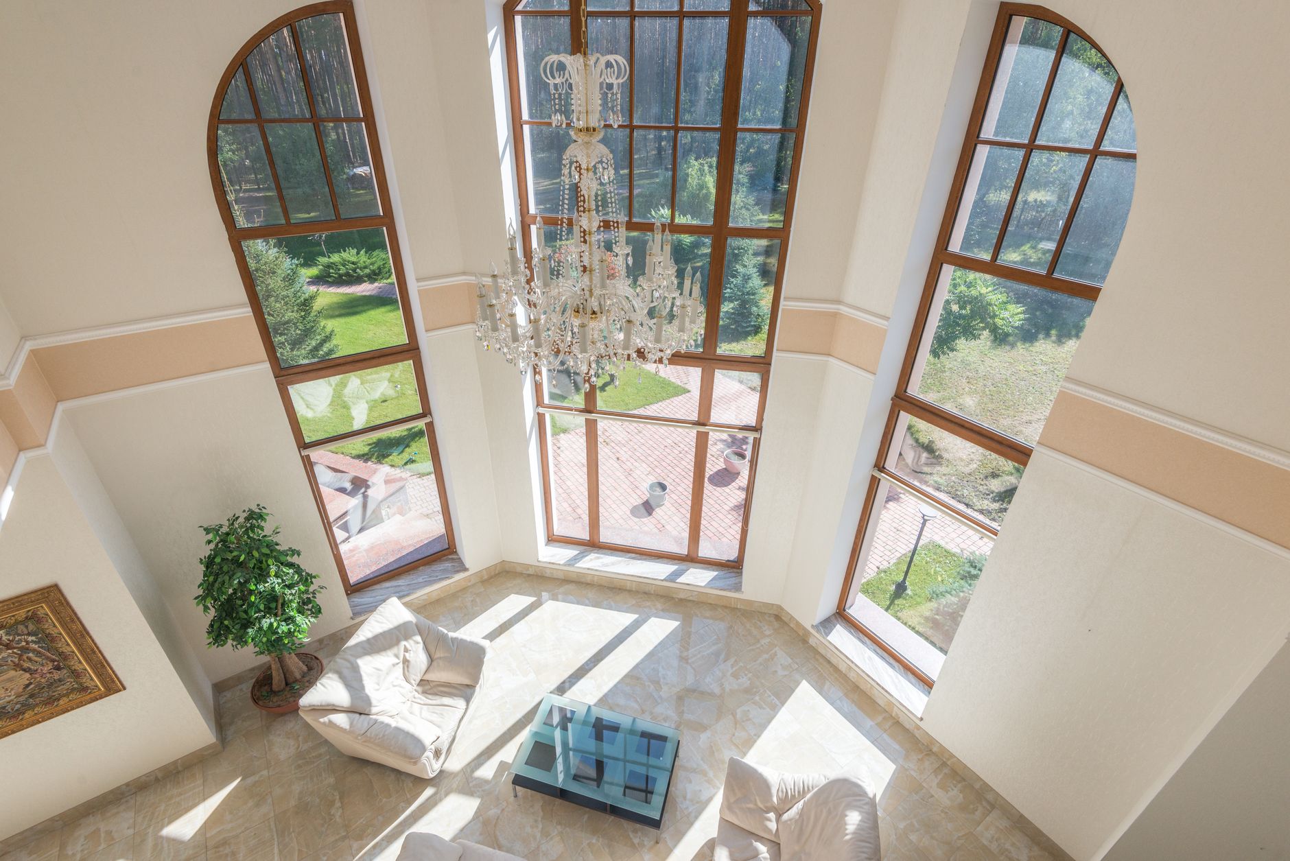 A tall room with arched windows and a chandelier