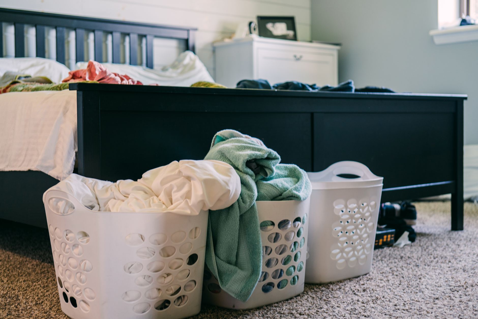 Bedding in a laundry basket ready to wash