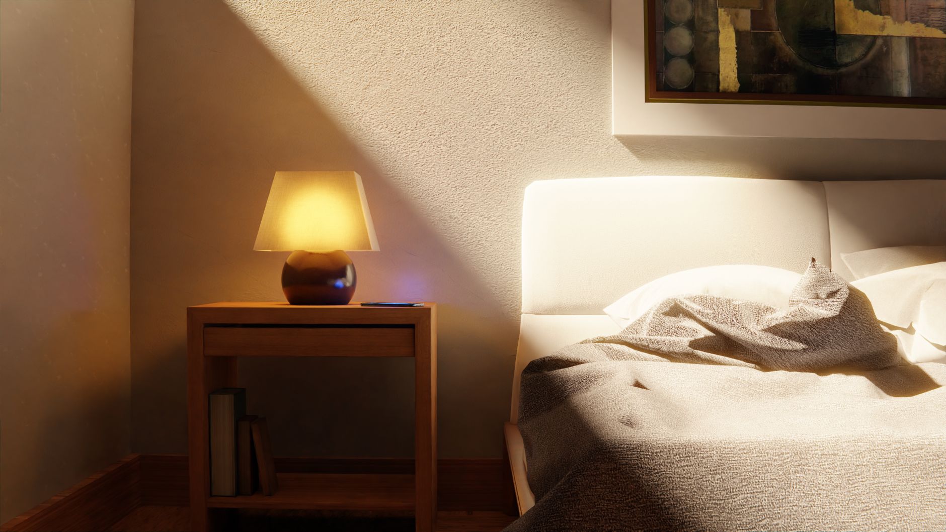 A bedside lamp glowing next to a bed