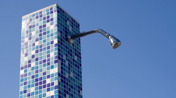 Best electric tankless water heater: an outdoor shower head on a tiled column