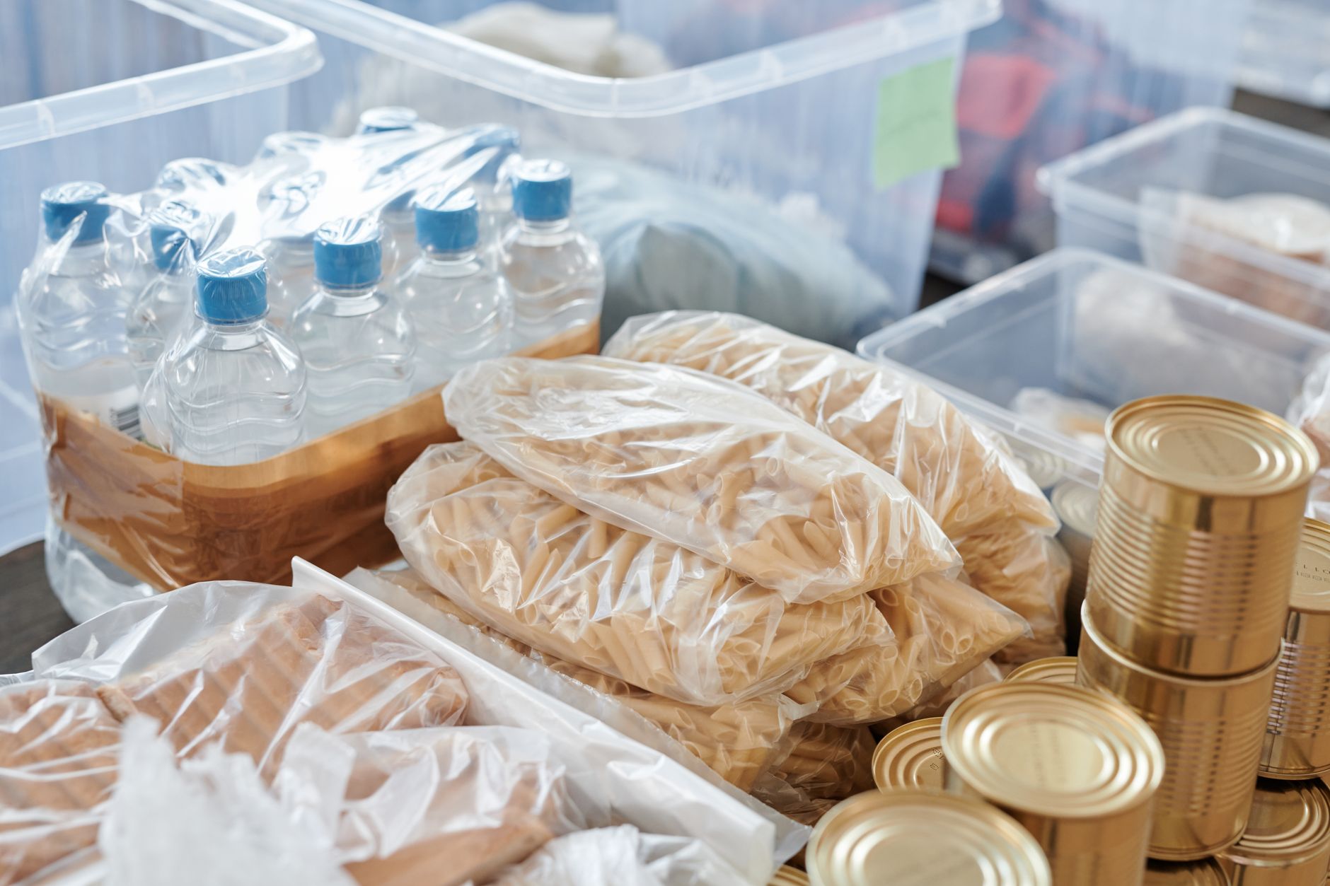 Bottled water, pasta and canned food stored in bins
