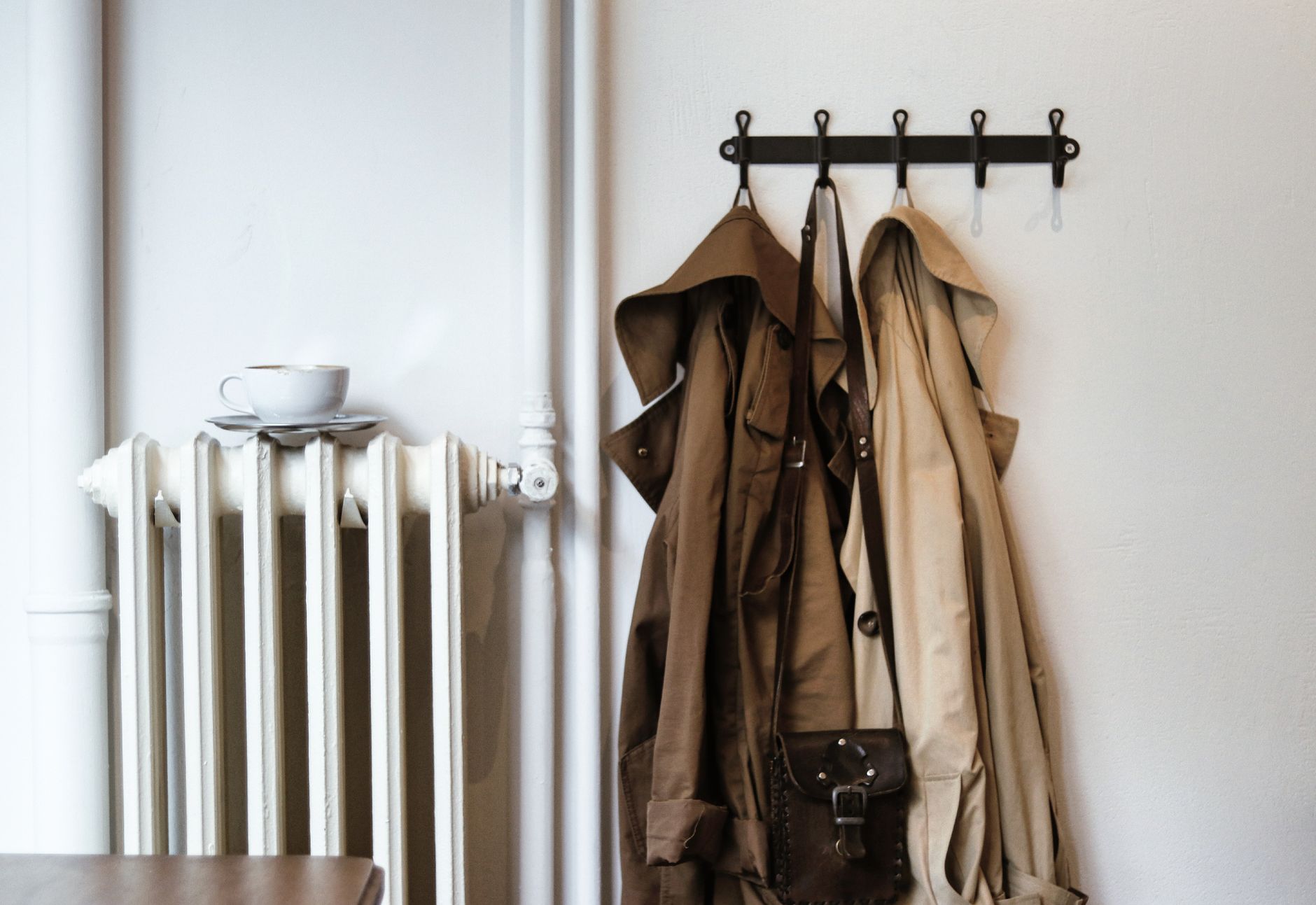 Coats hanging on hooks in a mudroom