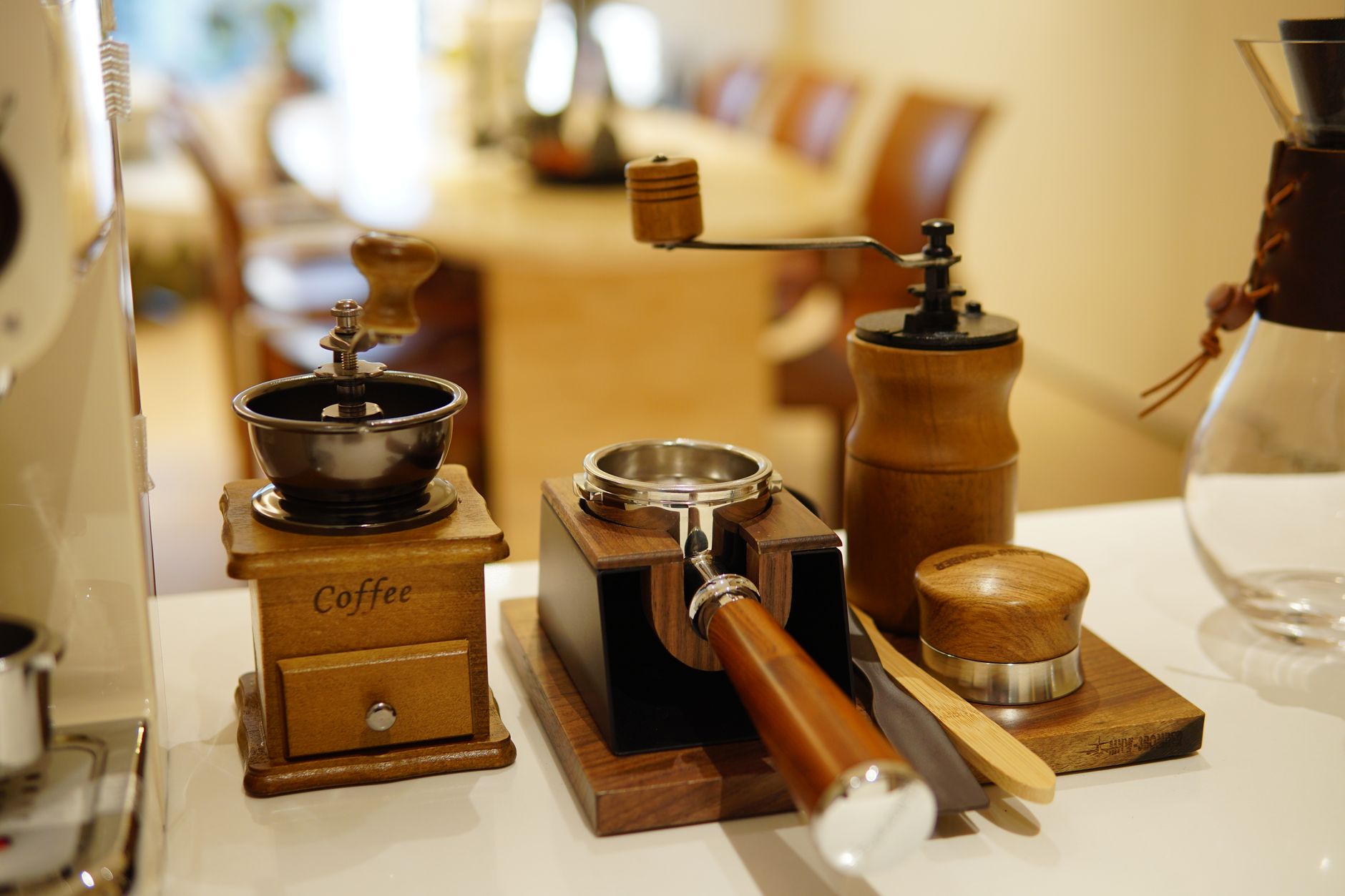 Vintage coffee grinder and espresso tools on a counter