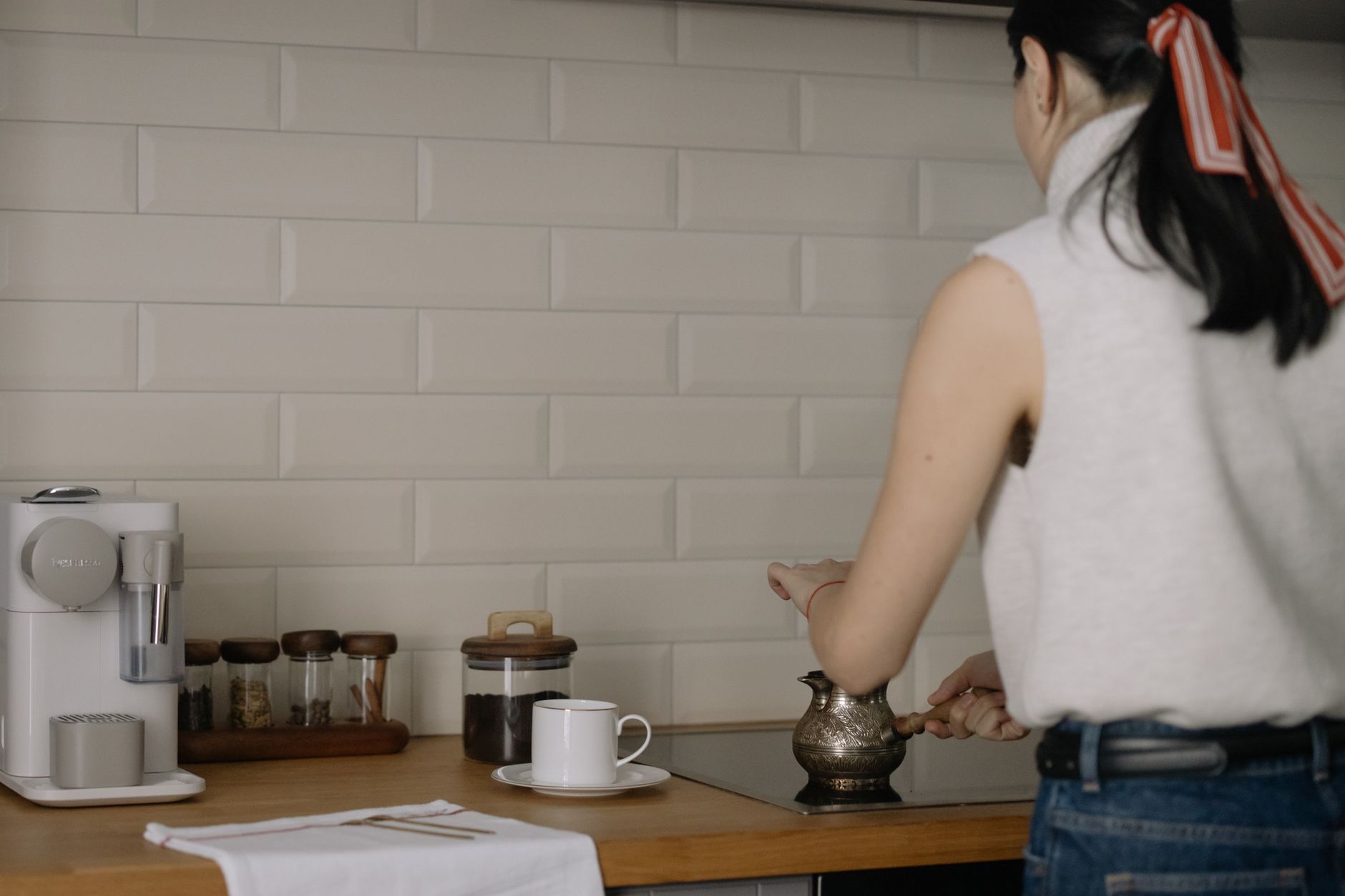 Woman at a kitchen counter with coffee equipment