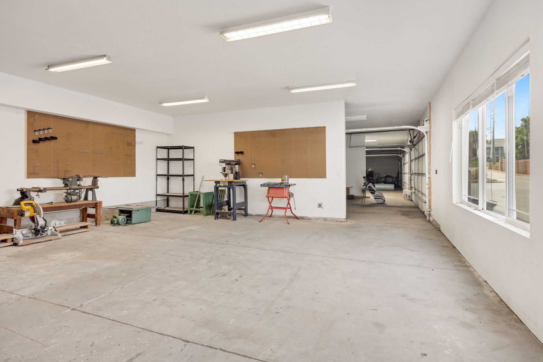 An empty garage with shelves and a workbench