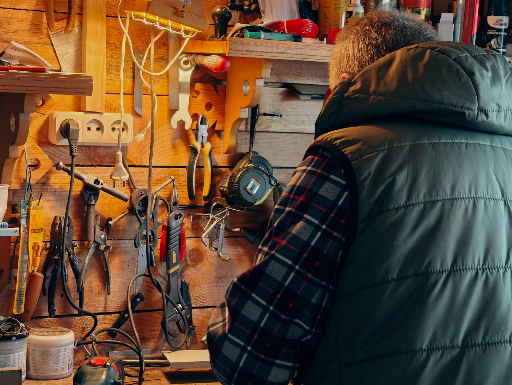 Hand tools hanging on a pegboard wall