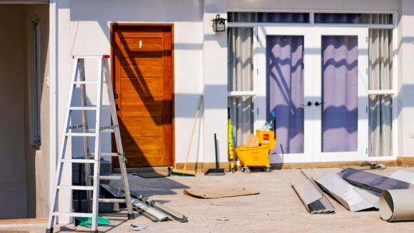 An aluminum ladder outside a house under renovation