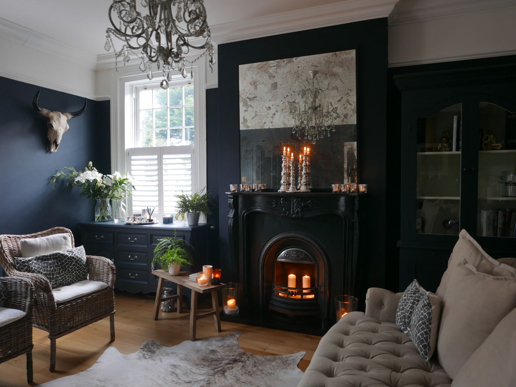 Candles glowing in a dark fireplace