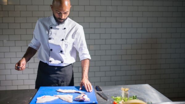 Best fillet knife: a chef portioning fish on a cutting board