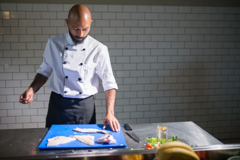 Best fillet knife: a chef portioning fish on a cutting board