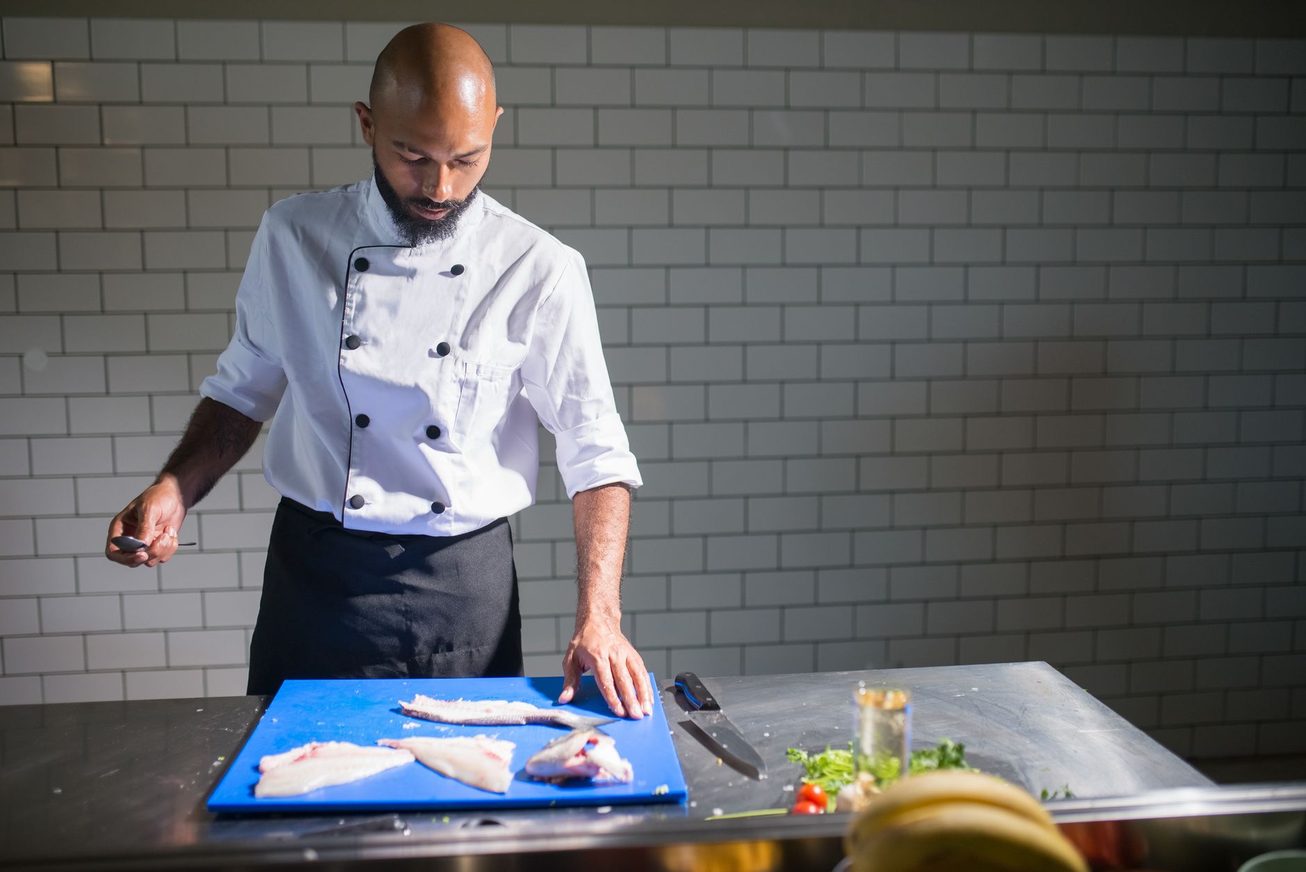 Best fillet knife: a chef portioning fish on a cutting board